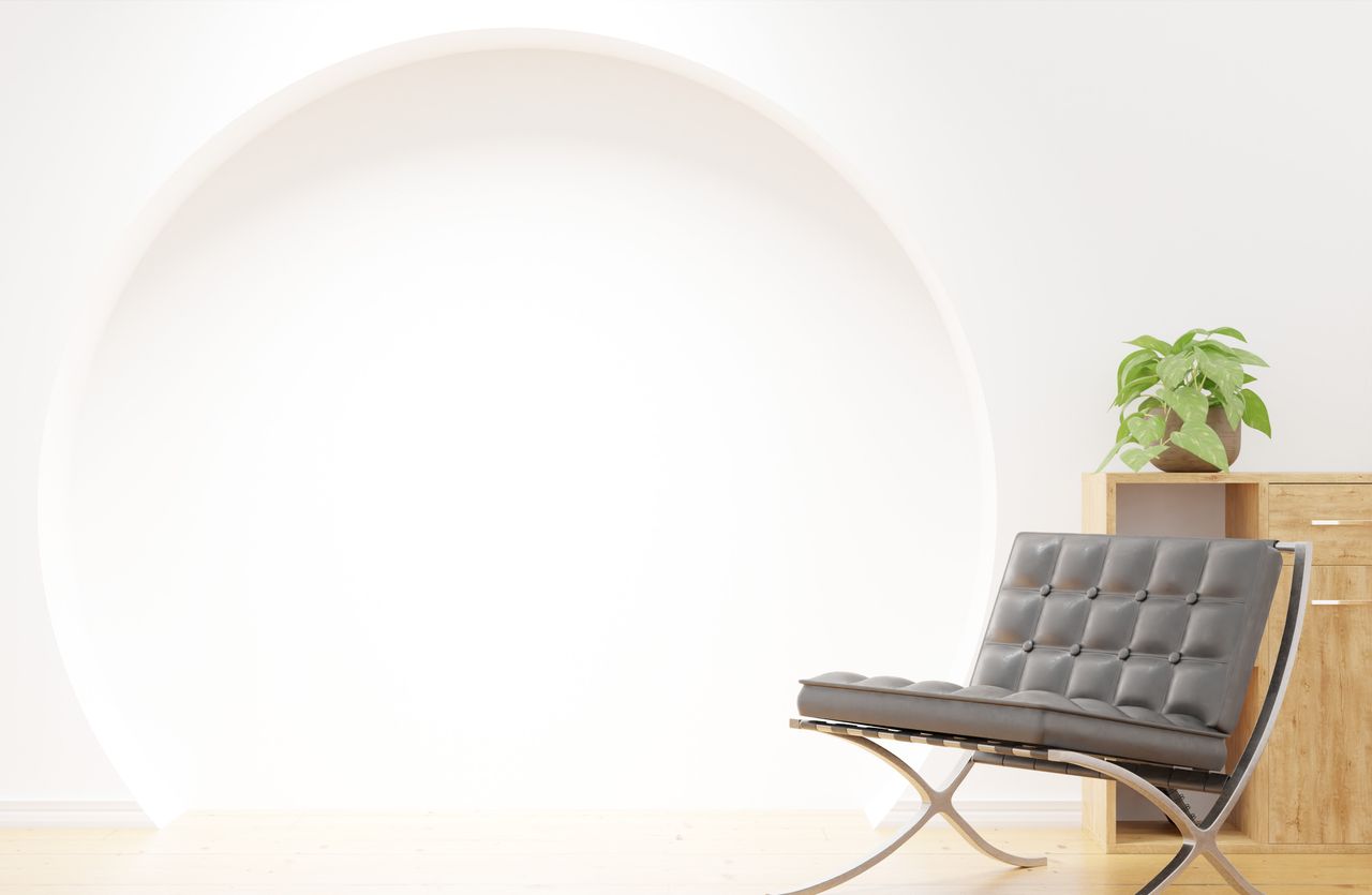 brand-02 A chic lounge nook with a contemporary chair and a potted plant, set within a minimalist environment.